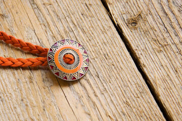 A contemporary take on the classic Western adornment is a sweat resistant bolo ties.
